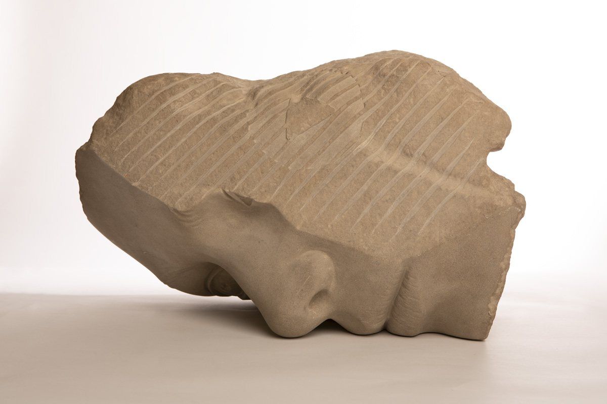 A portrait head carved from a salvaged limestone pillar, Memorylithics series